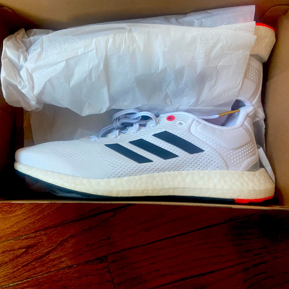 Men’s Adidas Pureboost, size 10.5, white, blue with red accents. New in box.